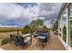 A charming back deck with patio furniture offers a relaxing outdoor space with picturesque views of the surrounding landscape at 11549 Haskell Creek Rd, Larkspur, CO 80118