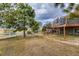 Backyard of the home, featuring a multi-tiered deck, outdoor seating, and spacious grassy area at 11549 Haskell Creek Rd, Larkspur, CO 80118