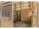 A stall in the barn, featuring wooden construction and metal bars, offering secure housing at 11549 Haskell Creek Rd, Larkspur, CO 80118