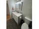 Modern bathroom featuring a white vanity with granite countertop and decorative backsplash at 11549 Haskell Creek Rd, Larkspur, CO 80118
