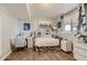 Bedroom featuring neutral walls and flooring, with a bright window and comfortable furniture at 11549 Haskell Creek Rd, Larkspur, CO 80118