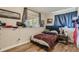 Comfortable bedroom with hardwood floors and ample natural light from the window at 11549 Haskell Creek Rd, Larkspur, CO 80118