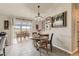 Inviting dining area featuring elegant lighting and scenic views through large glass doors at 11549 Haskell Creek Rd, Larkspur, CO 80118