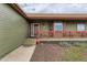 Inviting front porch with vibrant red railings and decorative accents, great curb appeal at 11549 Haskell Creek Rd, Larkspur, CO 80118