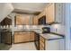 Charming kitchen with wood cabinets, granite countertops, and modern appliances, perfect for cooking at 11549 Haskell Creek Rd, Larkspur, CO 80118