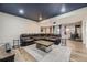 Basement living room with a dark blue ceiling, theater projector, and leather reclining sectional sofa at 11549 Haskell Creek Rd, Larkspur, CO 80118