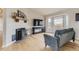 Cozy living room with fireplace, large window, and comfortable seating arrangement at 11549 Haskell Creek Rd, Larkspur, CO 80118