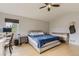 Cozy bedroom with natural light, complemented by neutral walls and ceiling fan at 11549 Haskell Creek Rd, Larkspur, CO 80118