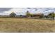 Wide shot of property, including detached garage and fenced yard with mature landscaping at 11549 Haskell Creek Rd, Larkspur, CO 80118