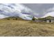 Expansive view of the property, showcasing the house, surrounding land, and distant mountain at 11549 Haskell Creek Rd, Larkspur, CO 80118