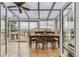 Bright sunroom with dining table and chairs, showcasing scenic views of the surrounding landscape at 11549 Haskell Creek Rd, Larkspur, CO 80118
