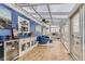 Inviting sunroom with glass ceiling, blue accent wall, and lots of light at 11549 Haskell Creek Rd, Larkspur, CO 80118