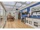 Bright sunroom featuring a dining table and a built-in beverage refrigerator at 11549 Haskell Creek Rd, Larkspur, CO 80118