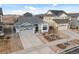 Aerial view of a single Gathering home with a gray roof, a two car garage, and manicured front yard at 15271 Grasslands Dr, Parker, CO 80134