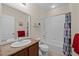 Bathroom featuring a single sink vanity, a shower-tub combo, and neutral finishes at 15271 Grasslands Dr, Parker, CO 80134