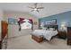 Comfortable bedroom with vaulted ceiling, soft natural light, and relaxing blue accent wall at 15271 Grasslands Dr, Parker, CO 80134