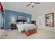 Bright bedroom featuring a large window, vaulted ceiling, and calming blue accent wall at 15271 Grasslands Dr, Parker, CO 80134