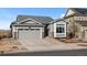 Lovely home showcasing appealing siding, a well-kept lawn, and a convenient two-car garage at 15271 Grasslands Dr, Parker, CO 80134