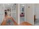 Hallway with hardwood floors providing entry to a bedroom and bathroom at 15271 Grasslands Dr, Parker, CO 80134