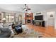 Cozy living room with a fireplace, hardwood flooring, and neutral décor with a mounted television and décor at 15271 Grasslands Dr, Parker, CO 80134