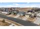 An aerial view of a suburban neighborhood featuring well-kept homes with driveways and green spaces at 15271 Grasslands Dr, Parker, CO 80134