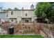 Home's backyard features green lawn, wooden fence, and an outdoor patio area at 1699 S Trenton St # 69, Denver, CO 80231