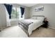 Bright bedroom with carpet, a neutral color scheme, and a window with curtains at 1699 S Trenton St # 69, Denver, CO 80231