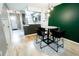 Open dining area with modern lighting, dark cabinetry, and hardwood floors connecting to the kitchen at 1699 S Trenton St # 69, Denver, CO 80231