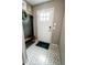 Inviting entryway boasts patterned tile flooring, coat hooks, and a stylish bench by the front door at 1699 S Trenton St # 69, Denver, CO 80231