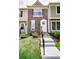 Charming townhouse featuring a well-manicured lawn and inviting entryway with concrete stairs and black railings at 1699 S Trenton St # 69, Denver, CO 80231