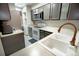 Galley kitchen with stainless steel appliances and updated cabinets at 1699 S Trenton St # 69, Denver, CO 80231