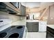 Galley kitchen with stainless steel microwave, updated cabinets and subway tile backsplash at 1699 S Trenton St # 69, Denver, CO 80231