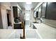 Updated galley kitchen with stainless steel appliances and modern cabinets at 1699 S Trenton St # 69, Denver, CO 80231