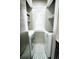 A laundry nook with stackable washer and dryer and grey patterned tile at 1699 S Trenton St # 69, Denver, CO 80231