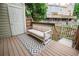 Cozy patio with a cushioned sofa, patterned rug, and wood deck perfect for outdoor relaxation at 1699 S Trenton St # 69, Denver, CO 80231