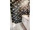 Stylish powder room with floral wallpaper, geometric tile, and modern vanity at 1699 S Trenton St # 69, Denver, CO 80231