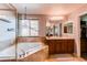 Bathroom with tub, walk-in shower, dual sink vanities, lots of natural light and mirror at 463 Mazzini St, Erie, CO 80516
