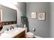 Stylish half-bathroom features a modern vanity, mirror, and artistic decor for a relaxing space at 463 Mazzini St, Erie, CO 80516