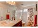 Bathroom featuring large mirror, vanity, and shower with patterned curtain at 463 Mazzini St, Erie, CO 80516