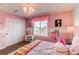 room with carpet, pink walls, chandelier, bed and view out the window at 463 Mazzini St, Erie, CO 80516