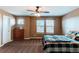 Comfortable bedroom with two windows, carpeted floors and a ceiling fan at 463 Mazzini St, Erie, CO 80516