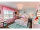 Charming bedroom with pink and blue walls, bright window and plush rug at 463 Mazzini St, Erie, CO 80516