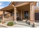 Inviting front porch with a covered entryway and cozy seating area at 463 Mazzini St, Erie, CO 80516