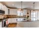 Bright kitchen features granite counters, a tile backsplash, and stainless steel appliances at 463 Mazzini St, Erie, CO 80516