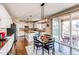 Open concept kitchen features granite counters, stainless appliances, an island, and eat-in dining space at 463 Mazzini St, Erie, CO 80516