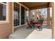 Covered patio with wrought iron table set, next to sliding glass doors at 463 Mazzini St, Erie, CO 80516