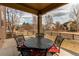 Outdoor patio with metal table and chairs overlooking a serene, fenced yard at 463 Mazzini St, Erie, CO 80516