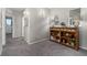 Hallway with a unique wooden console table, neutral gray walls, and cozy carpet, offering warmth and style at 6599 Pecos St, Denver, CO 80221