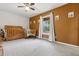 Bright bedroom featuring a vintage rocking chair, a wooden crib and a view of trees outside the window at 8170 Lt William Clark Rd, Parker, CO 80134