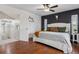 Modern bedroom features hardwood floors, a rustic bed frame, and a dark accent wall for a stylish touch at 8170 Lt William Clark Rd, Parker, CO 80134